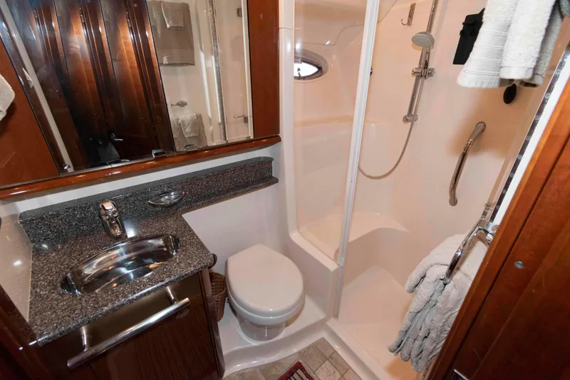 Slide: The Image of Luxurious bathroom in 2008 Sea Ray 52 Sedan Bridge yacht with shower and granite countertop. - 29