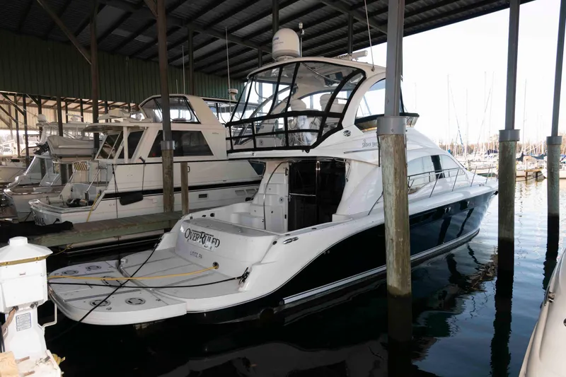 Slide: The Image of 2008 Sea Ray 52 Sedan Bridge yacht docked in a marina under a covered shelter. - 3