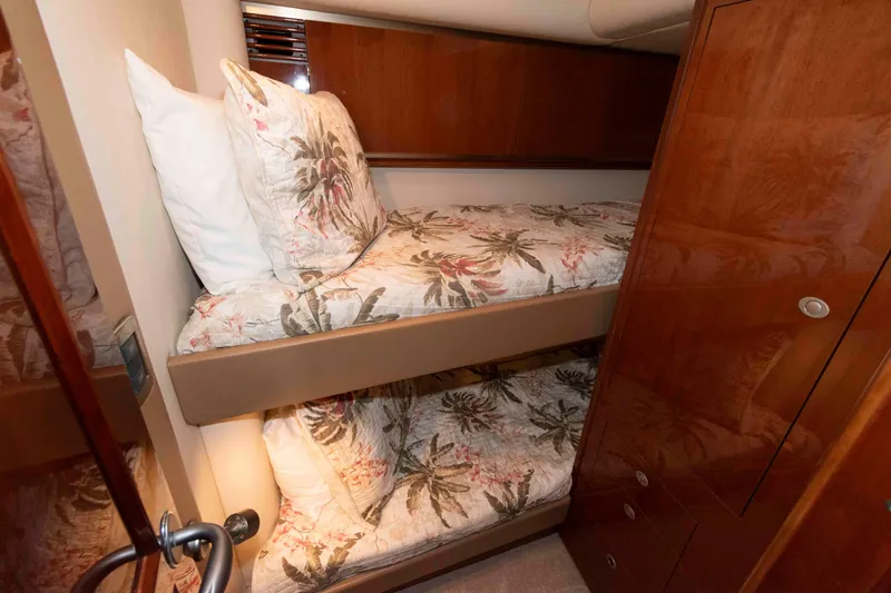 Slide: The Image of 2008 Sea Ray 52 Sedan Bridge cabin with bunk beds and floral bedding. - 32