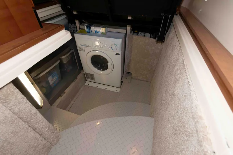 Slide: The Image of Laundry area inside 2008 Sea Ray 52 Sedan Bridge yacht, featuring a washing machine. - 34
