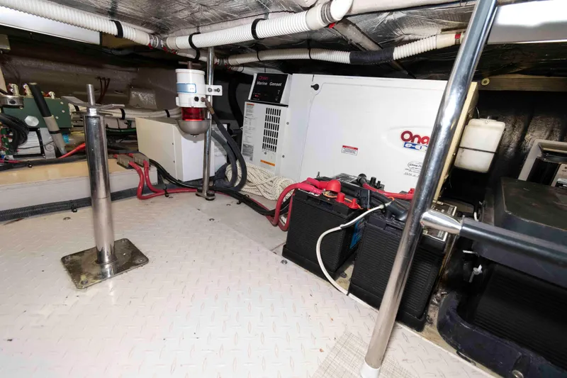 Slide: The Image of Engine room of 2008 Sea Ray 52 Sedan Bridge with generator and batteries. - 35