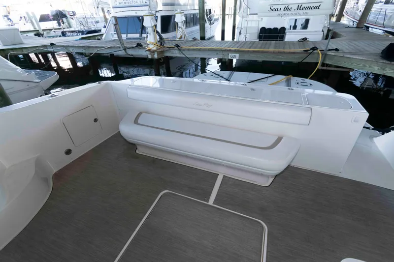 Slide: The Image of 2008 Sea Ray 52 Sedan Bridge yacht deck with seating, docked at marina. - 7