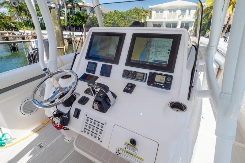 Slide: The Image of 2015 Intrepid 400 Center Console boat dashboard with navigation screens and controls. - 1