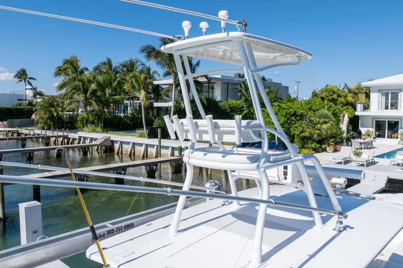 Slide: The Image of 2015 Intrepid 400 Center Console boat docked near waterfront homes. - 10