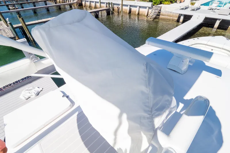 Slide: The Image of 2015 Intrepid 400 Center Console boat on lift over clear water. - 118