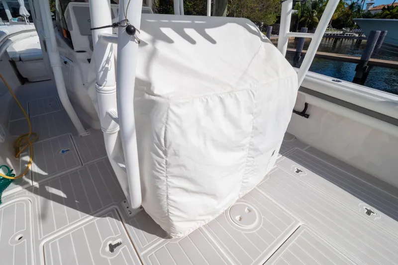 Slide: The Image of 2015 Intrepid 400 Center Console boat interior with covered seating and steering wheel. - 122