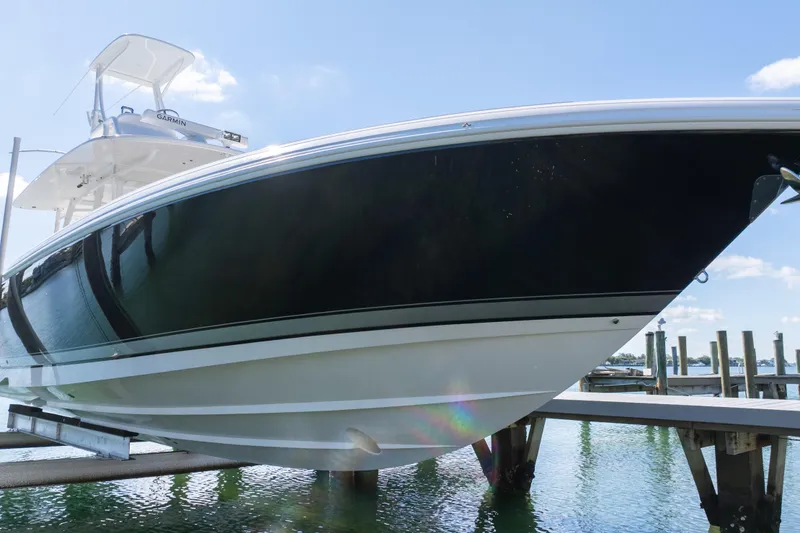 Slide: The Image of 2015 Intrepid 400 Center Console boat docked, showcasing sleek design and modern features. - 16