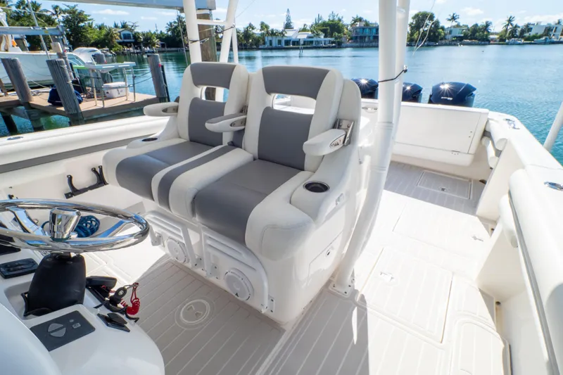 Slide: The Image of 2015 Intrepid 400 Center Console boat interior with dual seating and steering wheel. - 2