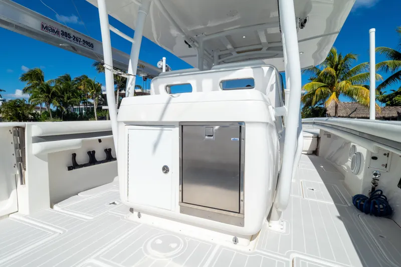 Slide: The Image of 2015 Intrepid 400 Center Console boat deck with storage, set against a tropical backdrop. - 48