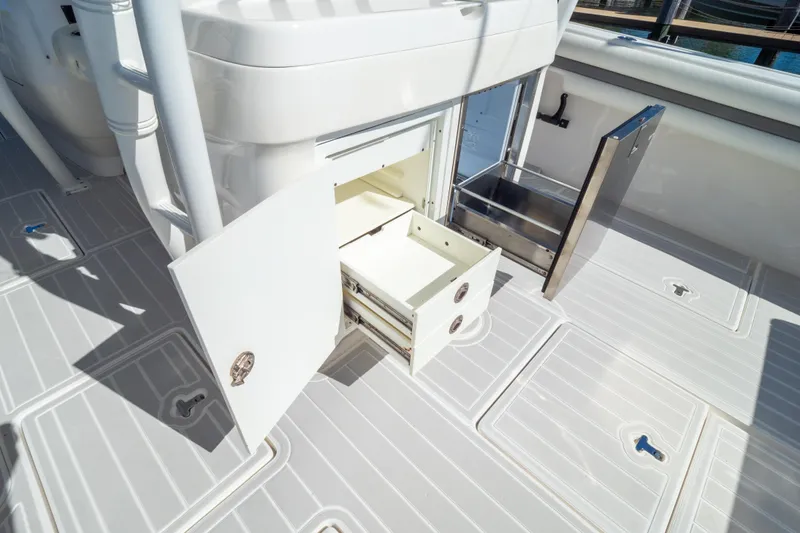 Slide: The Image of 2015 Intrepid 400 Center Console boat storage compartments open on deck. - 50