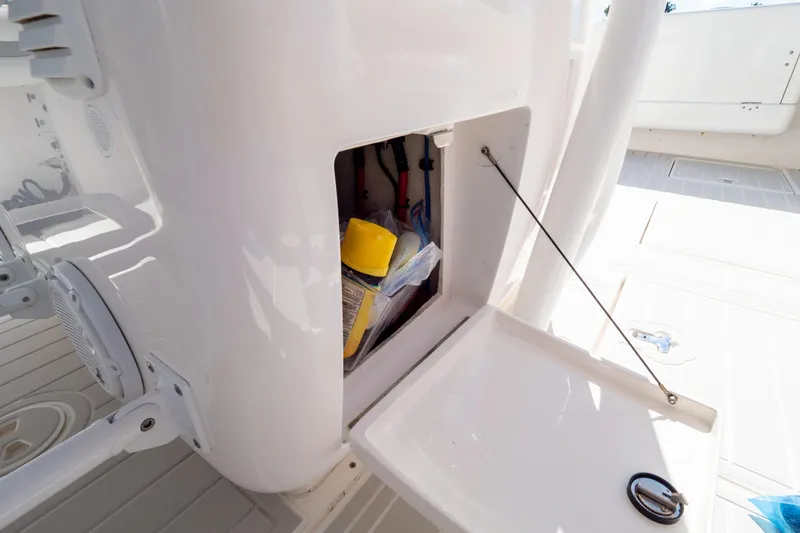 Slide: The Image of Open storage compartment on 2015 Intrepid 400 Center Console boat. - 54