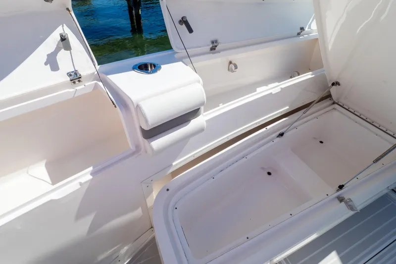 Slide: The Image of 2015 Intrepid 400 Center Console boat storage compartments open on deck. - 91