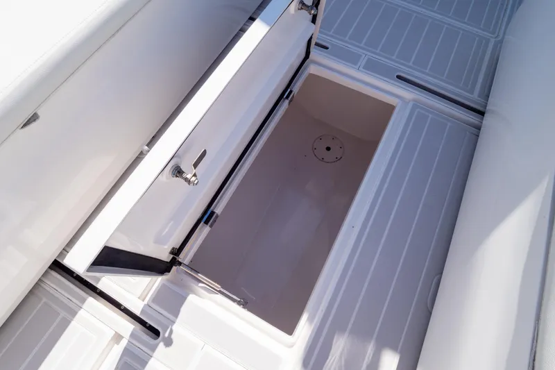Slide: The Image of 2015 Intrepid 400 Center Console boat storage compartments open on deck. - 92