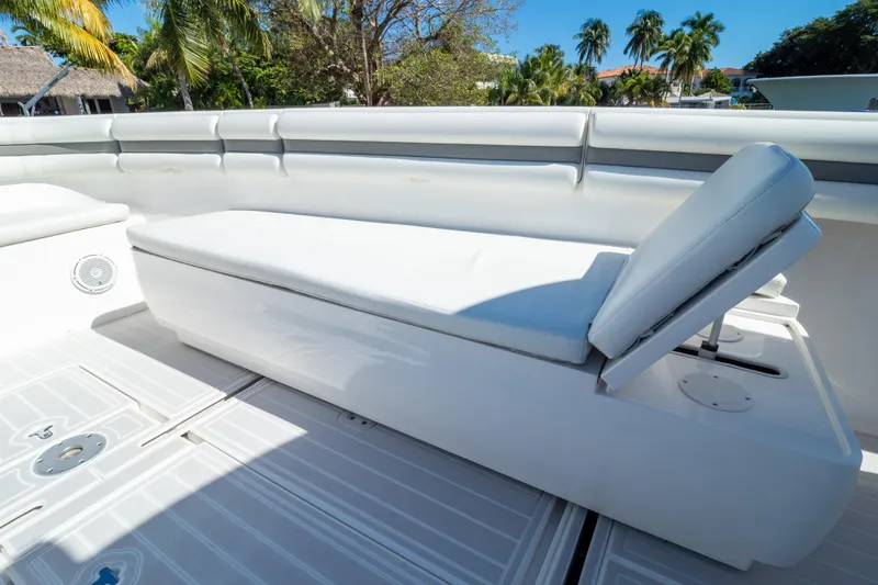 Slide: The Image of 2015 Intrepid 400 Center Console boat seating area with white cushioned bench. - 98