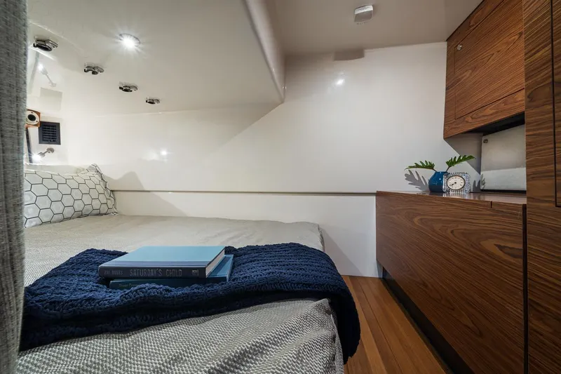 Slide: The Image of Manufacturer Provided Image: Luxurious cabin interior of 2026 Boston Whaler 405 Conquest with cozy bed and wooden cabinetry. - 18