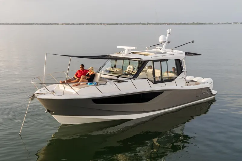 Slide: The Image of Manufacturer Provided Image: 2026 Boston Whaler 405 Conquest boat on calm water, with people relaxing on deck. - 4