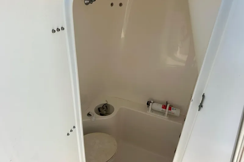 Slide: The Image of 2003 Venture 34 Center Console boat interior with toilet and fire extinguisher. - 10