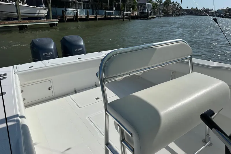 Slide: The Image of 2003 Venture 34 Center Console boat with dual 250 horsepower engines on a calm waterway. - 4