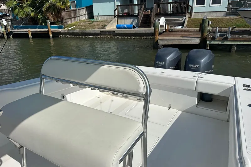Slide: The Image of 2003 Venture 34 Center Console boat with dual 250 horsepower engines docked by waterfront homes. - 5