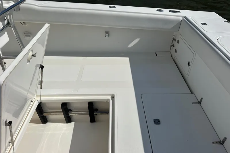 Slide: The Image of 2003 Venture 34 Center Console boat interior with open storage compartments. - 7