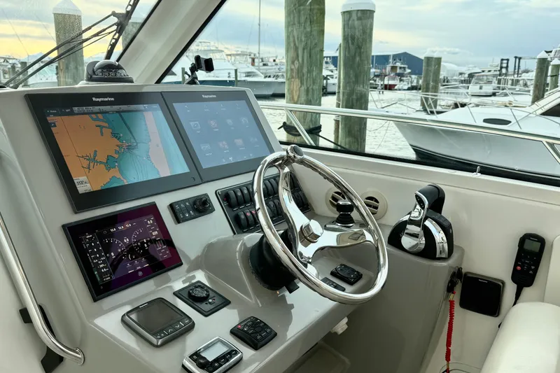 Slide: The Image of Control panel of 2014 Boston Whaler 345 Conquest Pilothouse with navigation screens and steering wheel. - 17