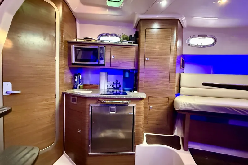 Slide: The Image of Interior of 2014 Boston Whaler 345 Conquest Pilothouse with kitchenette and seating area. - 21