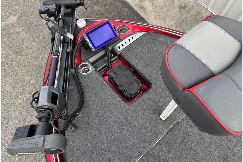 Slide: The Image of 2024 Triton 19 TrX Patriot boat deck with trolling motor and navigation display. - 3