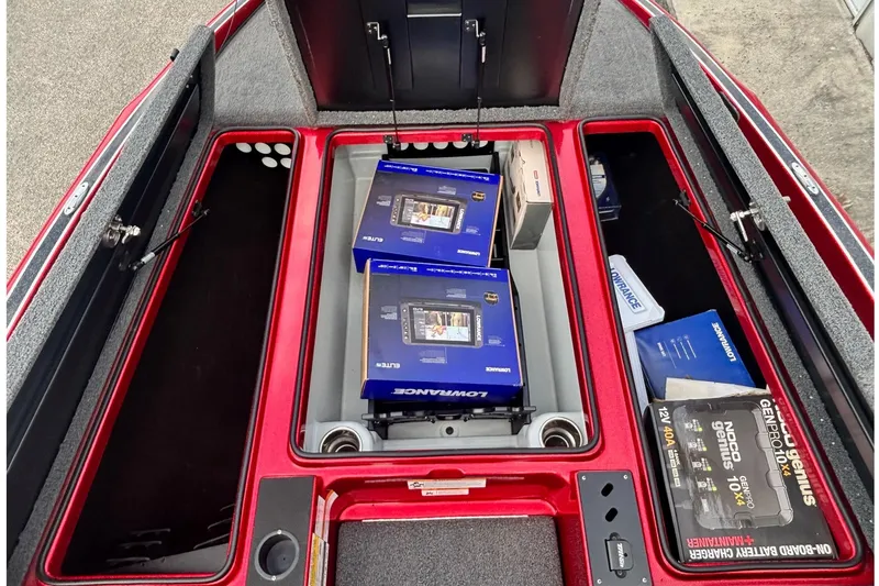 Slide: The Image of 2024 Triton 19 TrX Patriot boat storage with Lowrance electronics and battery charger. - 5