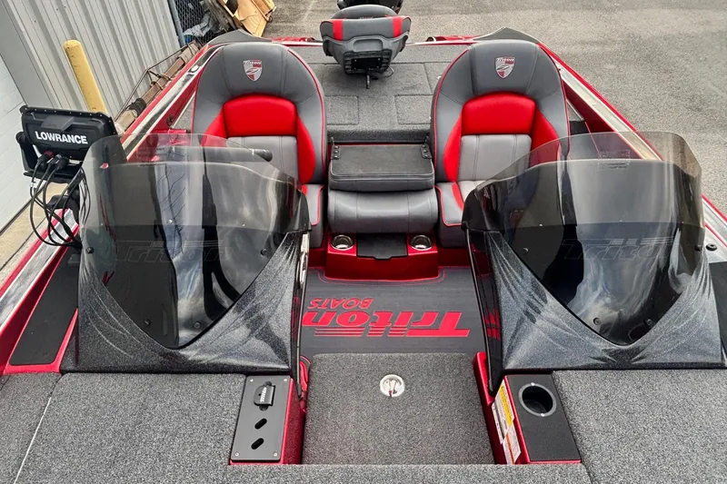 Slide: The Image of 2024 Triton 19 TrX Patriot boat interior with dual seats and Lowrance electronics. - 7