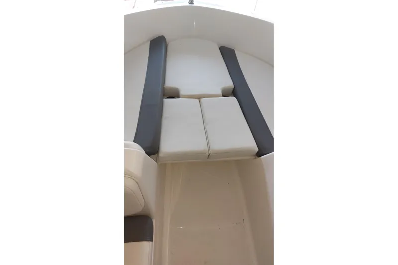 Slide: The Image of 2023 Bayliner Element E18 boat interior with cushioned seating area. - 10