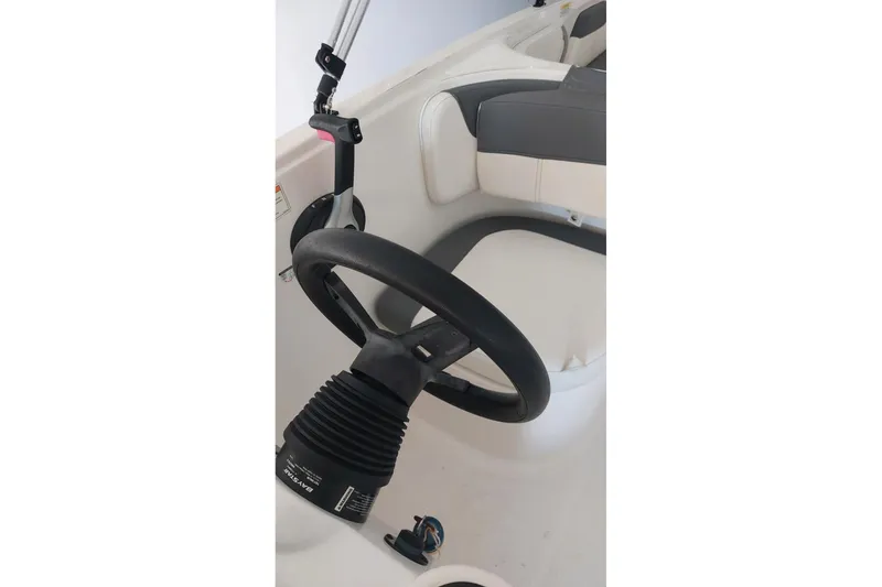 Slide: The Image of 2023 Bayliner Element E18 steering wheel and seating area, showcasing modern design. - 12