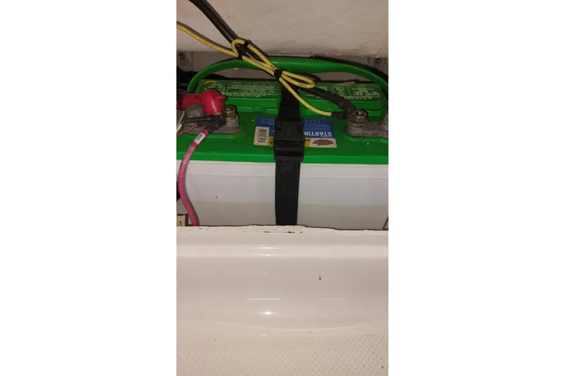 Slide: The Image of Battery compartment of 2023 Bayliner Element E18 boat with secured connections. - 9