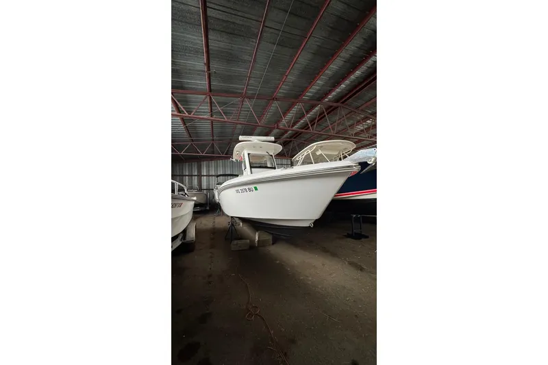 Slide: The Image of 2016 Everglades 255 Center Console boat in storage, side view. - 2