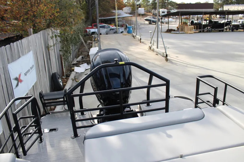 Slide: The Image of 2026 Starcraft EXS 3 Q boat with outboard motor in a marina setting. - 10