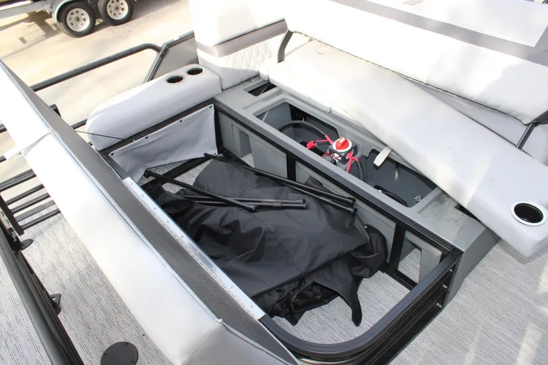 Slide: The Image of Open storage compartment in 2026 Starcraft EXS 3 Q boat, showcasing interior features. - 11