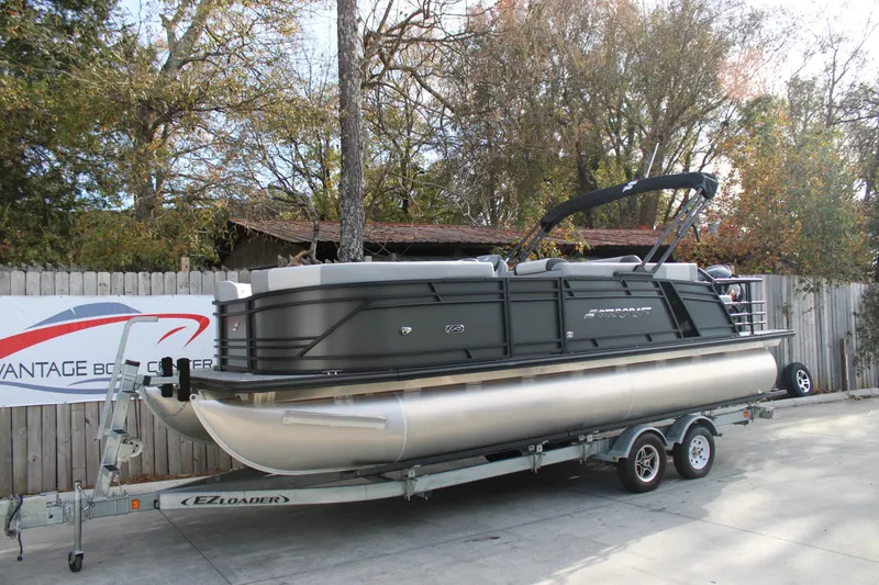 Slide: The Image of 2026 Starcraft EXS 3 Q pontoon boat on trailer, parked outdoors. - 2