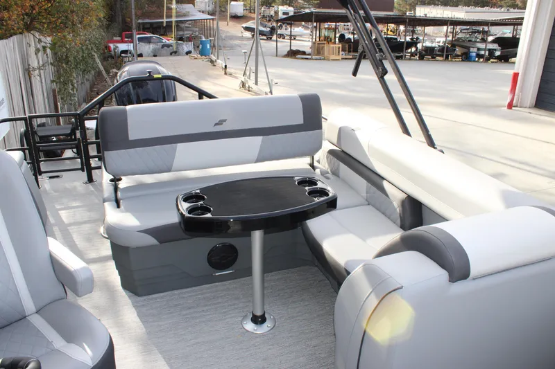 Slide: The Image of 2026 Starcraft EXS 3 Q boat interior with gray seating and a central table. - 4