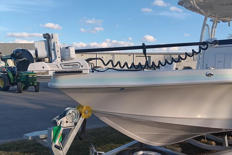 Slide: The Image of 2026 Ranger 2660 Bay boat with Minn Kota trolling motor on trailer, outdoor setting. - 6