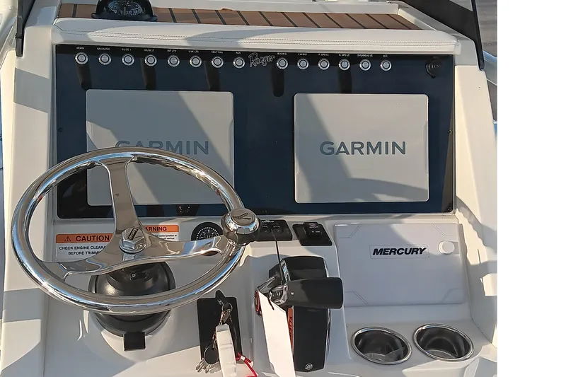 Slide: The Image of 2026 Ranger 2660 Bay boat dashboard with Garmin displays and Mercury controls. - 9