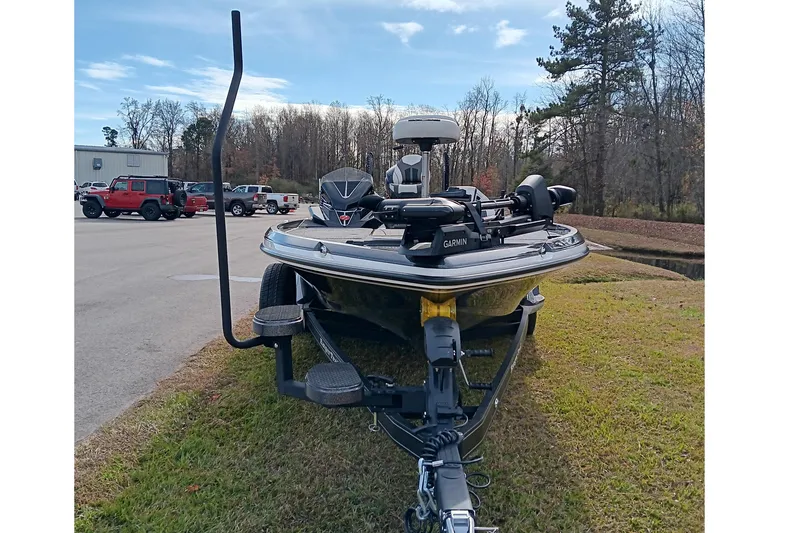 Slide: The Image of 2026 Ranger Z521R Cup-Equipped boat on trailer, parked on grass near trees and vehicles. - 10