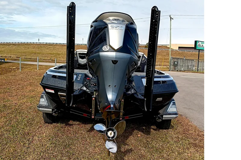 Slide: The Image of 2026 Ranger Z521R Cup-Equipped boat, rear view with powerful engine, parked on grass. - 6