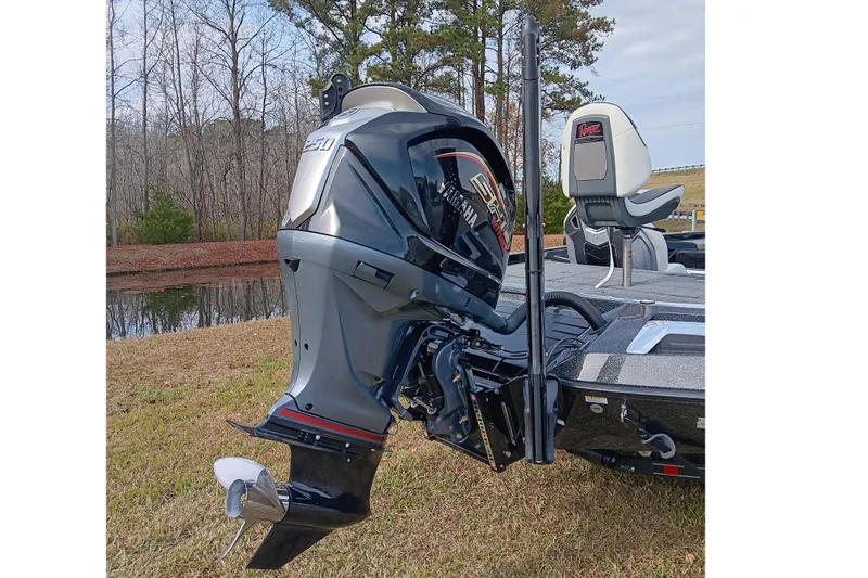 Slide: The Image of 2026 Ranger Z521R Cup-Equipped boat with powerful outboard motor, parked on grassy lakeside. - 8