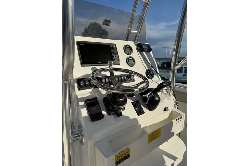 Slide: The Image of 2026 Key West 239 FS boat console with steering wheel and navigation controls. - 2