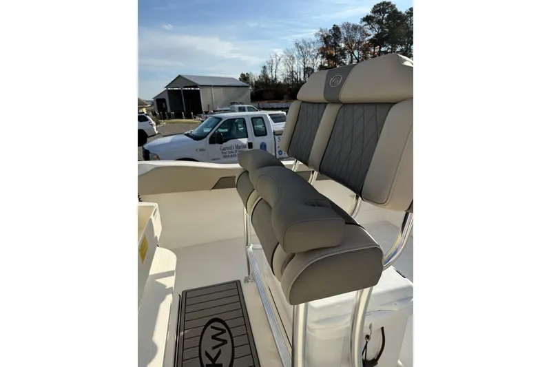Slide: The Image of 2026 Key West 239 FS boat interior with cushioned seating and KW logo. - 3