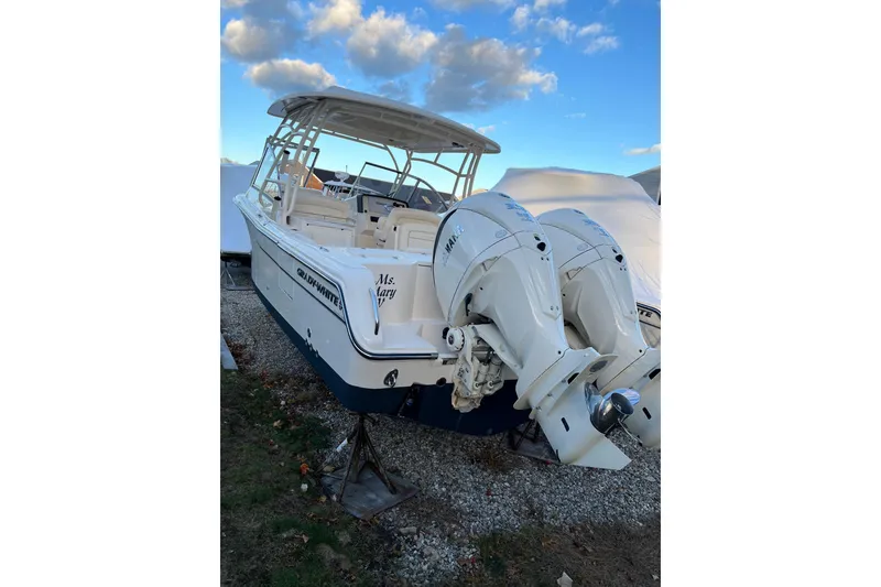 Slide: The Image of 2024 Grady-White Freedom 285 boat with dual Yamaha outboard engines, docked outdoors. - 2