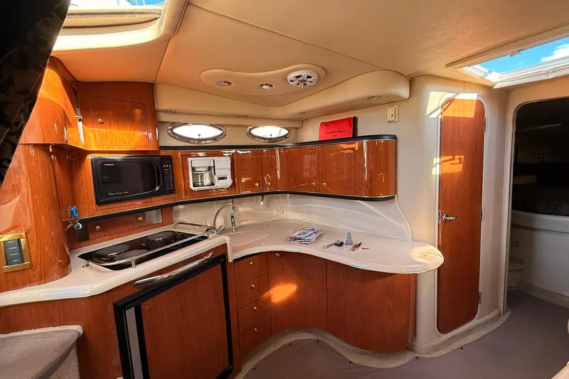 Slide: The Image of Luxurious interior of a 1999 Sea Ray 370 Sundancer yacht with plush seating and modern amenities. - 11