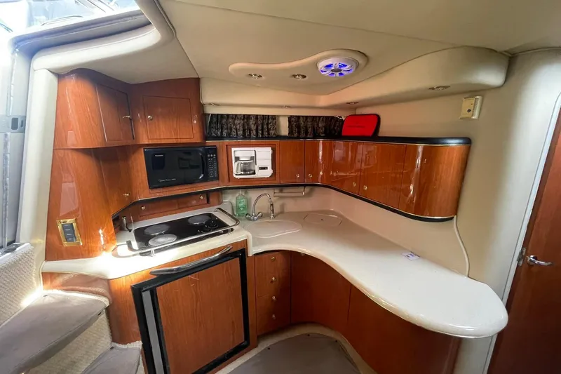 Slide: The Image of Interior of 1999 Sea Ray 370 Sundancer yacht with plush seating and modern amenities. - 12
