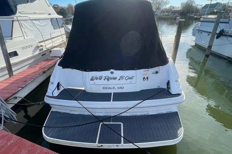 Slide: The Image of 1999 Sea Ray 370 Sundancer docked, covered, with "We'll Figure It Out" text, Deale, MD. - 4