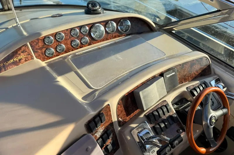 Slide: The Image of 1999 Sea Ray 370 Sundancer helm with wood accents and modern navigation instruments. - 7