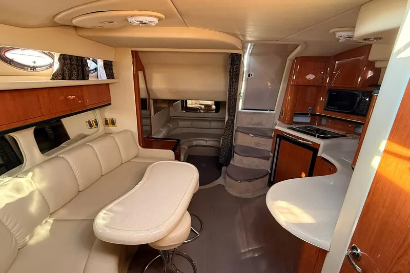 Slide: The Image of 1999 Sea Ray 370 Sundancer helm with wood accents and modern navigation equipment. - 8